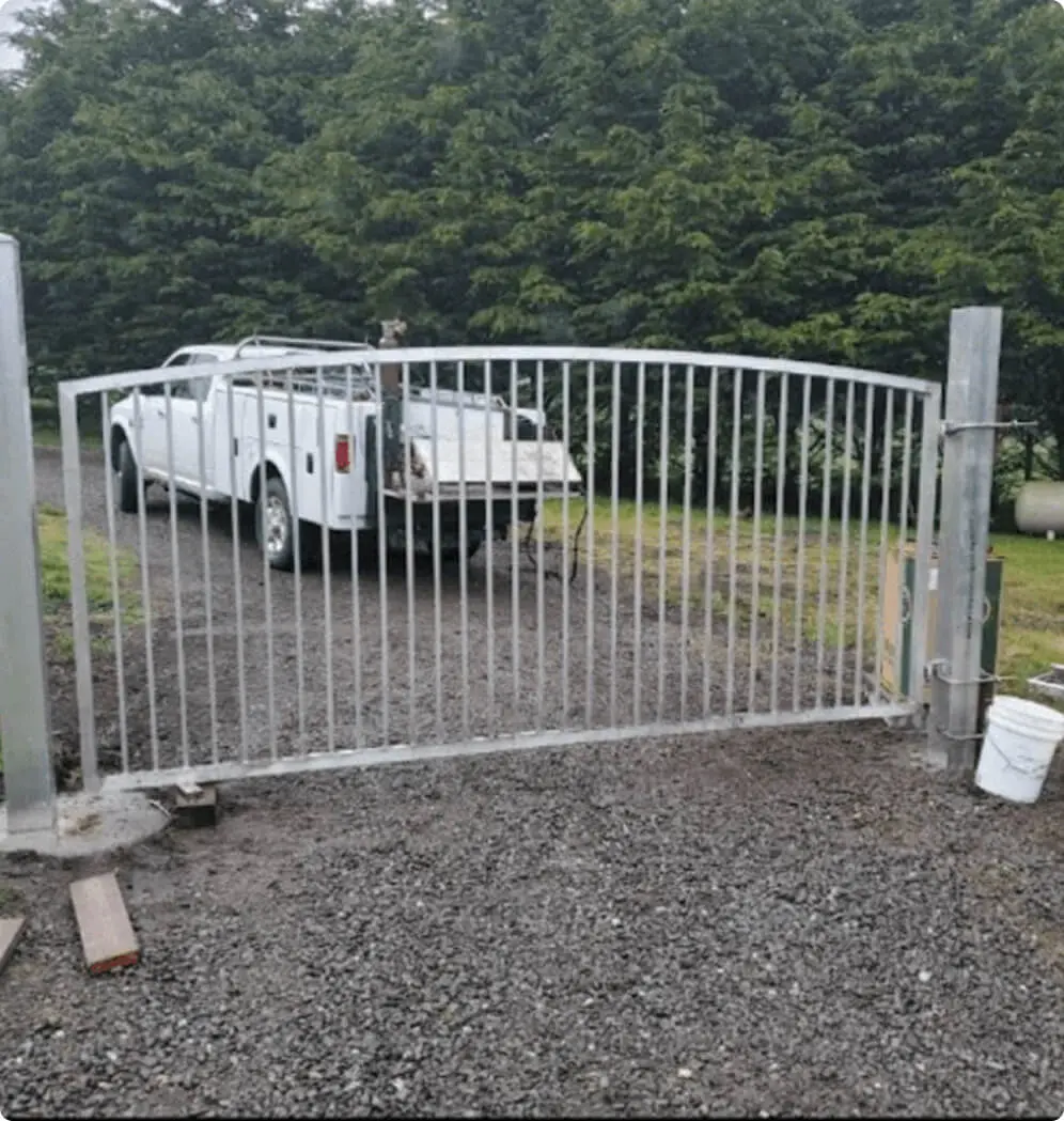 White truck behind a metal gate